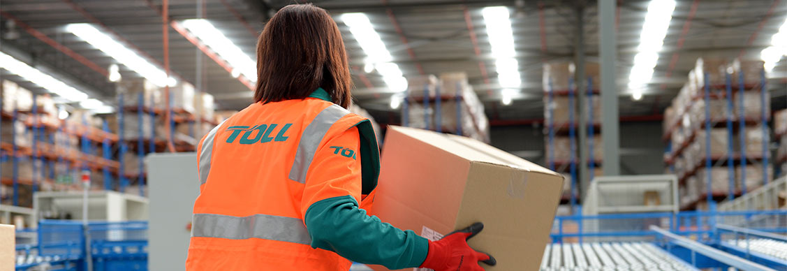 A worker picking up a parcel