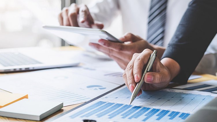 Business accountants working on graph documents