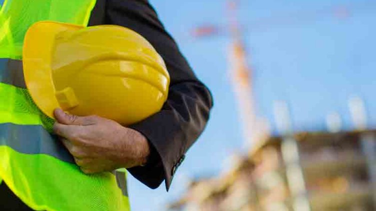 Picture of real estate construction worker holding helmet
