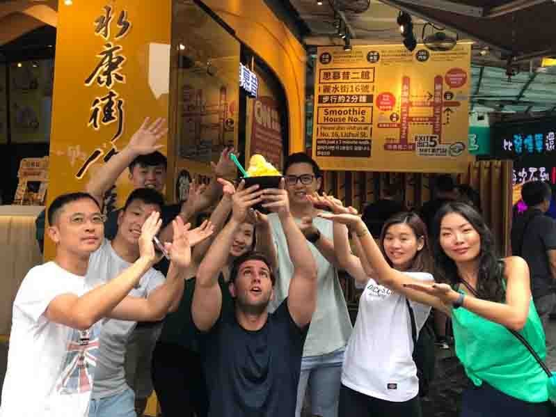 Friends taking picture and holding smoothie icecream in their hand