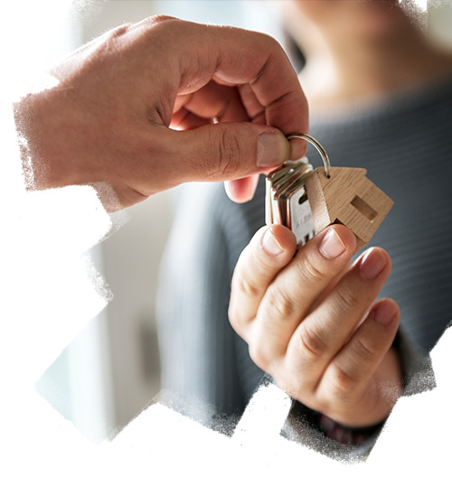 Real estate consultants handling keys of residential apartment to customer