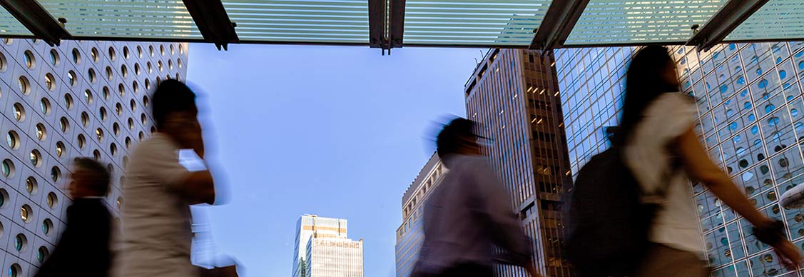 Peoples are walking in between the buildings