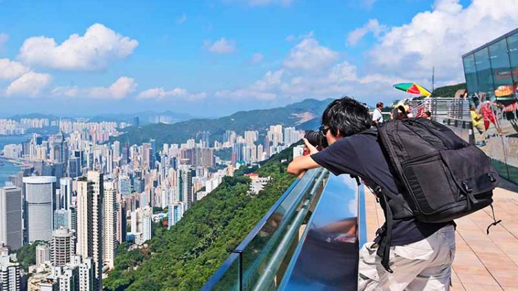 Boy taking picture of HK city