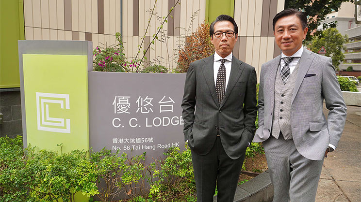 two men taking photos in front of C.C. Lodge