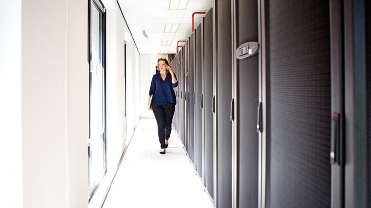 Women talking on phone while walking in the corridor