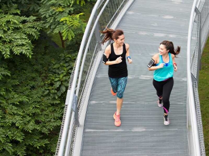 Two Young Women Are Running In The Morning