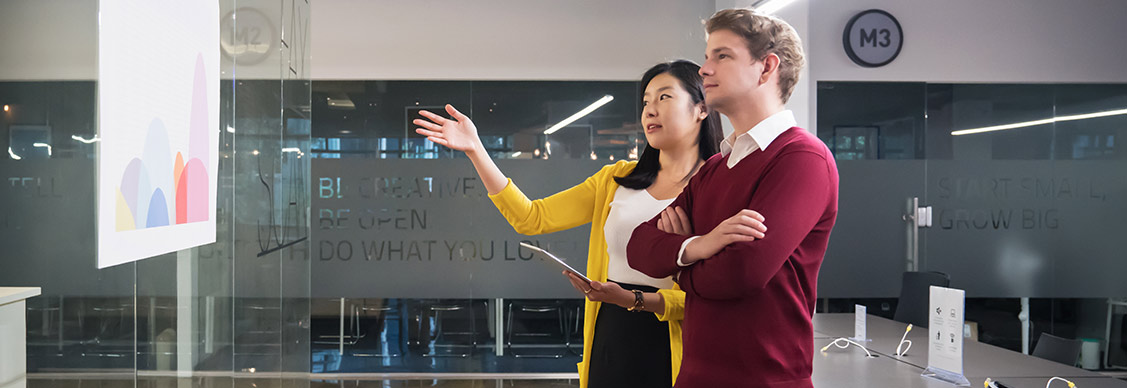 Two businessmen talking about a project in modern office.
