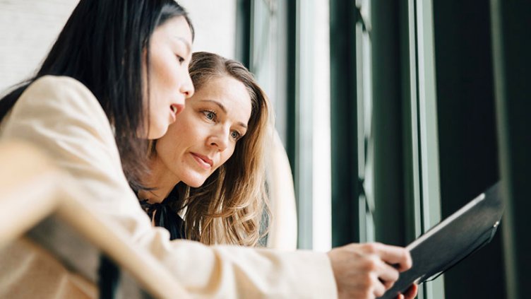 Two women looking at a document