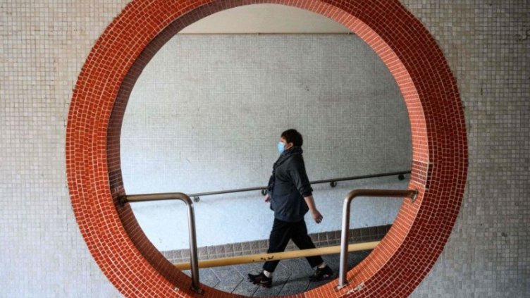 A female employee walking while wearing a mask
