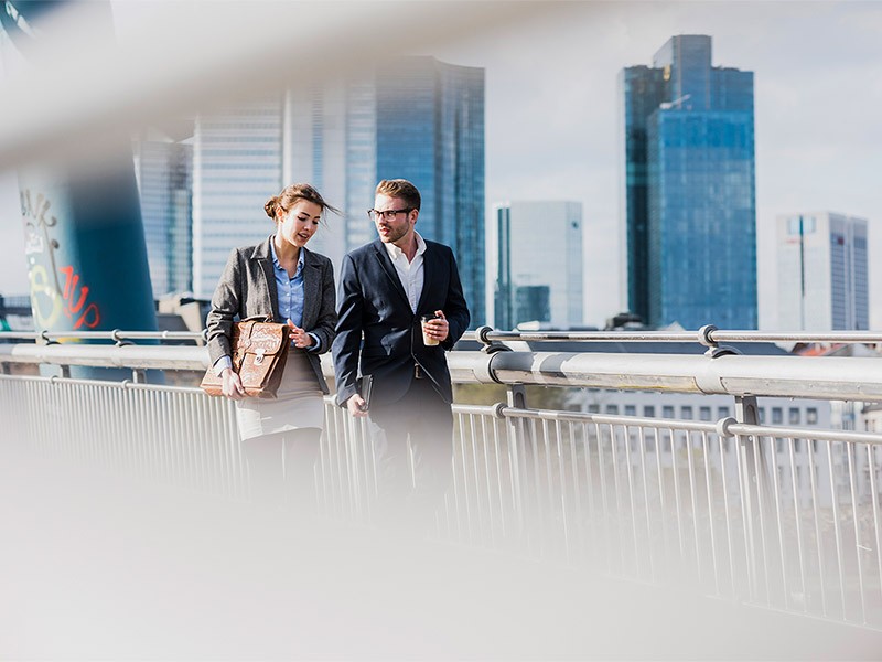 A male and female talking to each other while going office