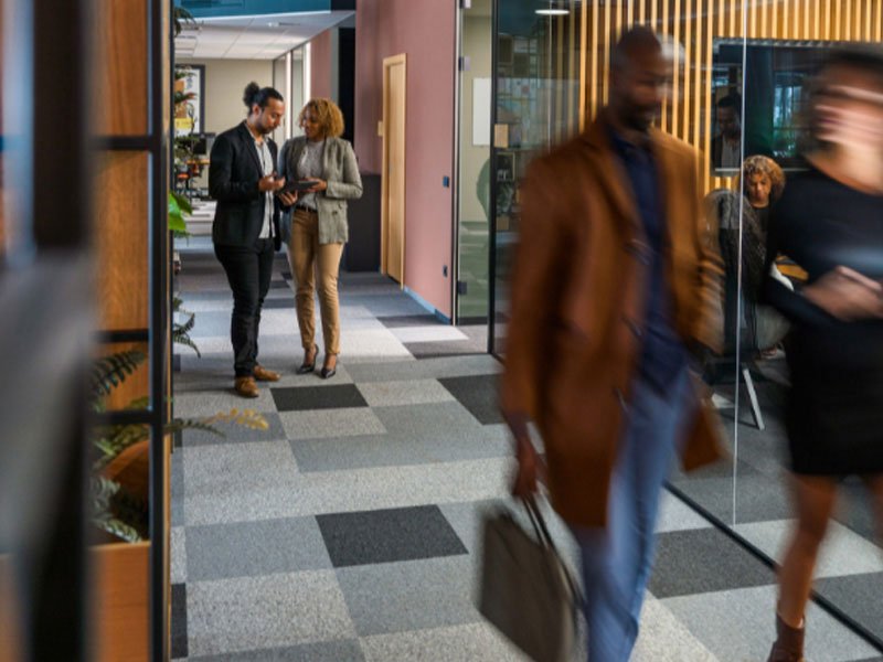 People discussing on the corridor at office
