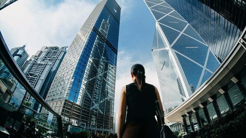 Woman looking at the huge skyscraper buildings 