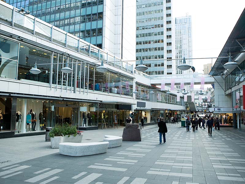 People are walking infront of the Shopping mall