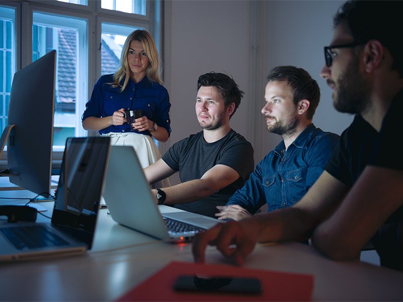 Four people watching the system