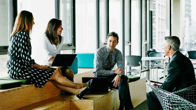 Group of people having informal meeting in office