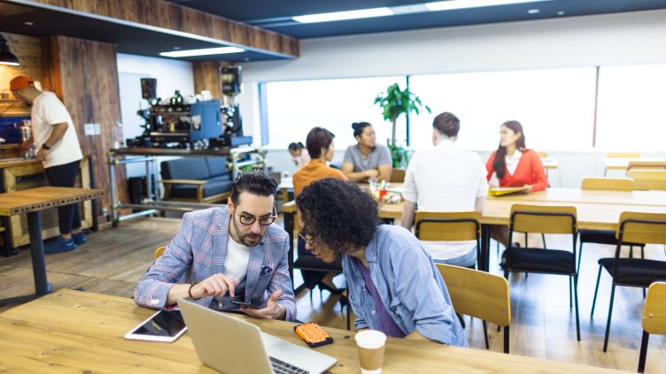 Multi-ethnic people are working together in a modern co-working space.